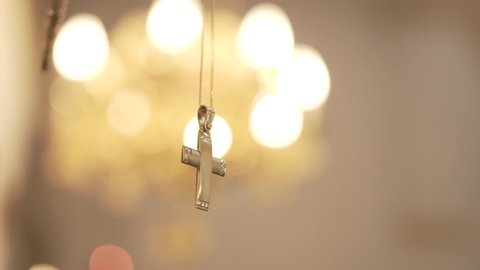 Βaptismal cross in church with bokeh close up