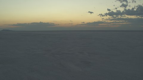 Aerial Drone Shot of the Dry Lake Desert Bed, Cinematic Fly Over above the dry lake ground during beautiful sunset