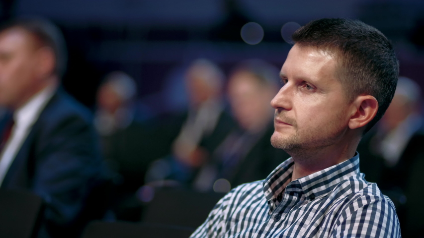 Audience business meeting crowded forum person. Viewer seminar education listen speaker large auditorium. Event financial summit business man spectator. Group people listening speech crowd audience.