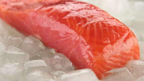 fresh salmon steak on ice cubes rotating