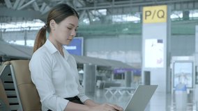 Social distancing, businesswoman wearing face mask sit working with laptop keeping distance away from each other to avoid covid19 infection during pandemic. Empty chair seat red cross shows new normal - Powered by Shutterstock - Get 15% off with code: PIKWIZARD15