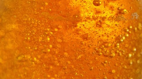 Super Slow Motion Detail Shot of Beer Bubbles in Glass at 1000fps.