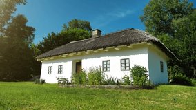 Old white Ukrainian hut with thatch roof in the settlement - Powered by Shutterstock - Get 15% off with code: PIKWIZARD15