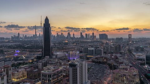Aerial city view at warm evening with downtown and financial center towers, transition from day to night Timelapse in illuminated Dubai city, United Arab Emirates after sunset