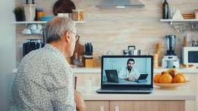 Senior couple having a video conference with doctor talking ill treatment. Online health consultation for elderly people drugs ilness advice on symptoms, physician telemedicine webcam. Medical care
