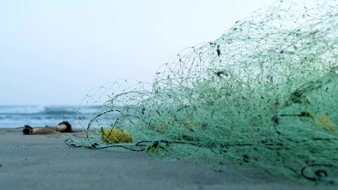 fishing net on the beach.
artisanal fishing. fishing net lying on the shore