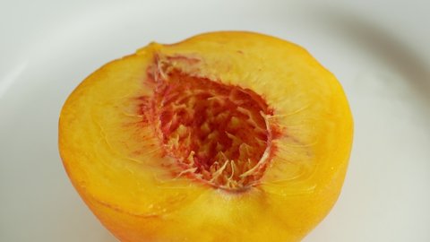Rotation of a juicy peach. 360 degree rotation, extreme close-up. Peach orange juicy tree fruit.

