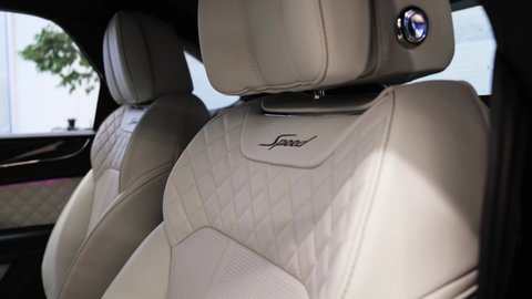 Moscow, Russia - July, 2020: Bentley Bentayga W12 SUV interior in black and white colors. Close up view of the leather driver seat