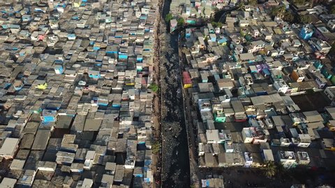 Aerial View of Dharavi Slum and Dirty Water Canal in Mumbai India. Poor Housing and Lack of Hygiene in Famous Neighborhood