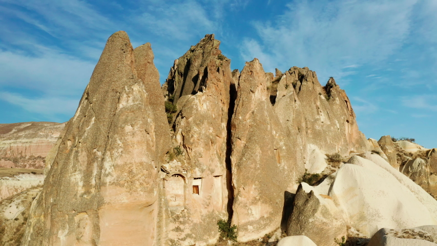 Stone formation of Cappadocia with carved dwellings in hillside, Aerial view