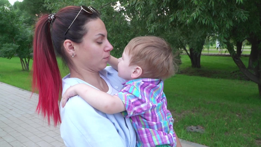 Boy and mom are fooling around in her arms