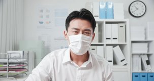 Telemedicine concept - Asian businessman wear face mask who is sick and he talk to doctor on telemedicine in office