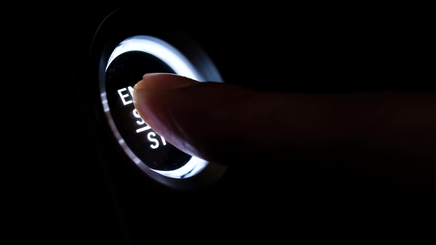 The driver's hand is pressing the car start button. Concept of transportation and technology | Shutterstock HD Video #1058212744