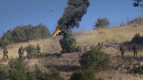 Soldiers in war on hill with smoke and helicopter
unidentified IDF Israeli force Soldiers on hill in Golan Heights
