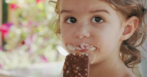 Cute Toddler Girl Eating Ice Cream And Making A Mess. Shot on a cinema camera.