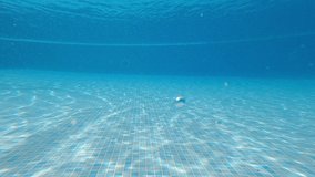 Young teen boy have fun swimming underwater at the pool in summer active holiday vacation activity - caucasian people enjoy active lifestyle swim at the swimming pool - Powered by Shutterstock - Get 15% off with code: PIKWIZARD15