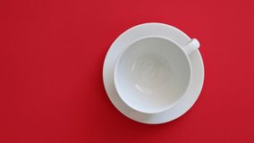 Pouring a Cup of Coffee on a Red Background.