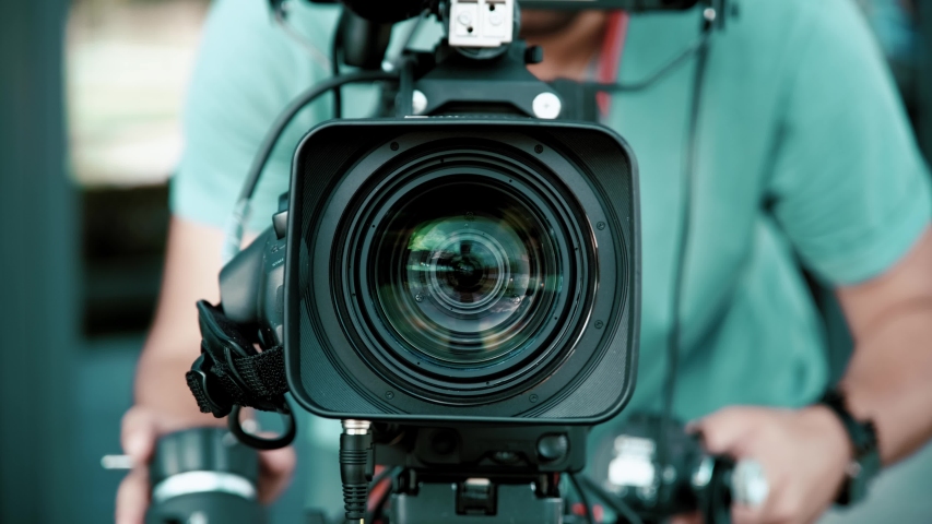 Professional shot of young cameraman shooting a scene Royalty-Free Stock Footage #1058233306