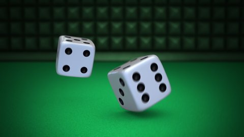 Rolling White Dice.  A pair of white die drop to a felt table and roll.