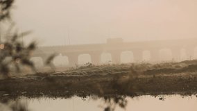 The nature of Southeast Asia is beautiful in form of landscape with quiet river, fog and reflection of rising sun. On horizon there are mountains and an stone arch bridge. Thailand - Powered by Shutterstock - Get 15% off with code: PIKWIZARD15