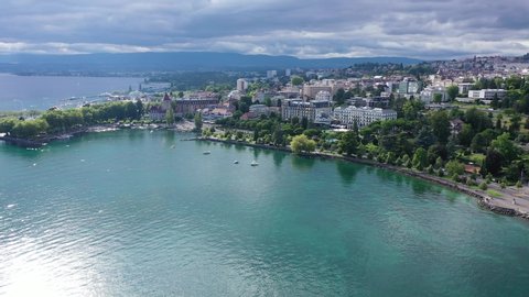 View from Lake Leman of residential areas of Swiss city of Lausanne in cloudy summer day, canton of Vaud in Romandy