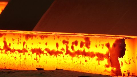 Hot steel pouring in steel plant. Metallurgical production, heavy industry, engineering, steelmaking. Red hot steel metal billets after molten steel casting. Continuous casting machine.