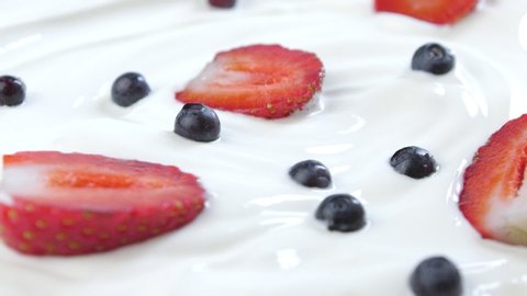 Delicious strawberries and blueberries in white cream