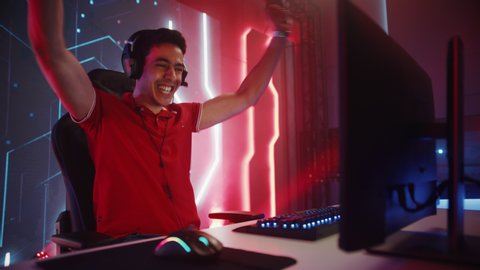 Professional eSports Gamer Playing in Computer Video Games, Happily and Cheerfully Celebrates Victory and Success. Online Cyber Championship / Tournament. Portrait Side View, Static Camera Shot