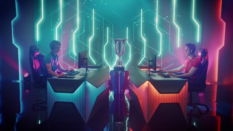 Two Professional eSports Gamers take places at Gaming Stations, put on Headphones, take Controllers, Start Playing on a Cyber Games Championship Event. Competitive Online Live Streaming Tournament