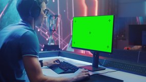 On Video Game Championship Professional eSports Gamer Plays on Green Chroma Key Screen Personal Computer. Online Live Streaming Cyber Gaming Tournament Stylish Retro Neon Room