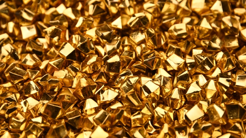 Abstract background of colorful bright golden nuggets spin and flicker, 4K