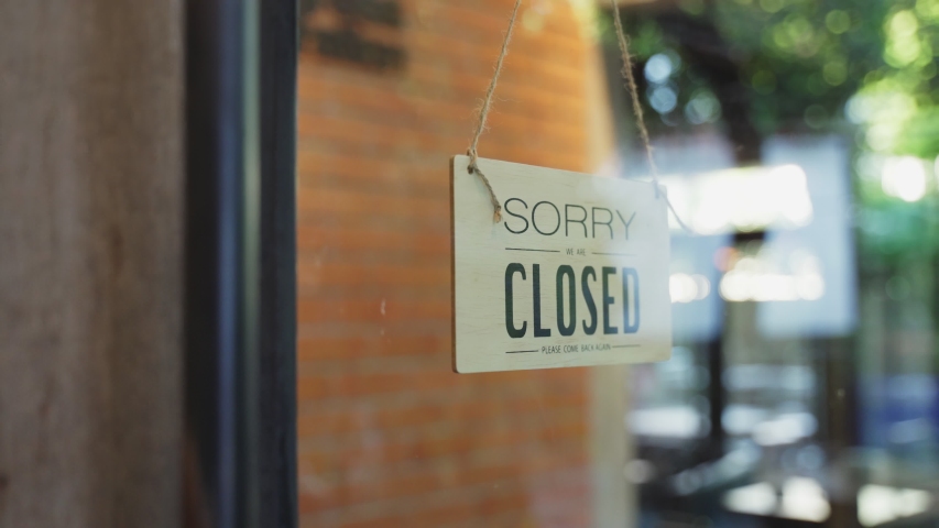 Cafe or restaurant and business reopen after Coronavirus quarantine is over. Man with face mask turning a sign from closed to open on a door shop. Small food shop business after post covid lockdown. | Shutterstock HD Video #1058267041