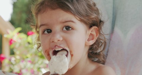 Cute Toddler Girl Eating Ice Cream And Making A Mess. Shot on a cinema camera.