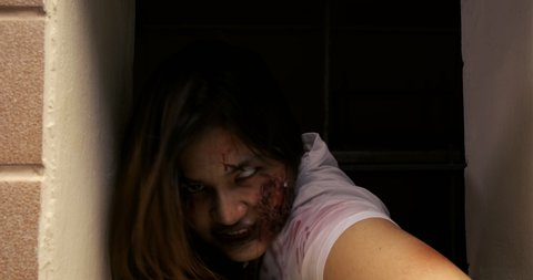 Zombie characters ghost woman bite human in wall horror halloween at nightmare, Female evil screaming monster in night background infected with bleed movie scene film in holiday festival concept.