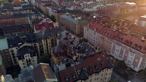 Stockholm city at sunset aerial view. Drone shot flying over apartment buildings and street in central Stockholm, Sweden