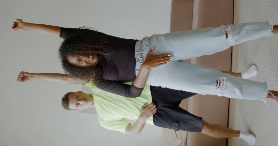 VERTICAL VIDEO POV Interracial couple or friends recording trendy dance moves for social media account | Shutterstock HD Video #1058276392