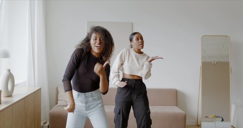 Two African-American Black ladies recording trendy dance moves for social media account