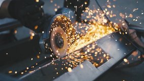 Man works circular saw. Sparks fly from hot metal. Man hard worked over the steel. Close-up slow motion shot in garage - Powered by Shutterstock - Get 15% off with code: PIKWIZARD15