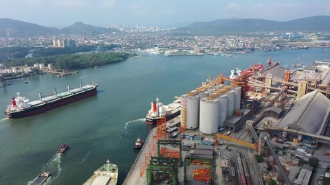Aerial view of Freighter Ship in Santos Port in Dark River. Porto de Santos, Sao Paulo, Brazil. Container ship. Porto de Santos, Sao Paulo, Brazil. Freigther Ship in Sea.  Maritime Transport