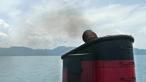 Smoke from pipe on ferry boat. Air pollution and ecology concept. Sky with cloud background
