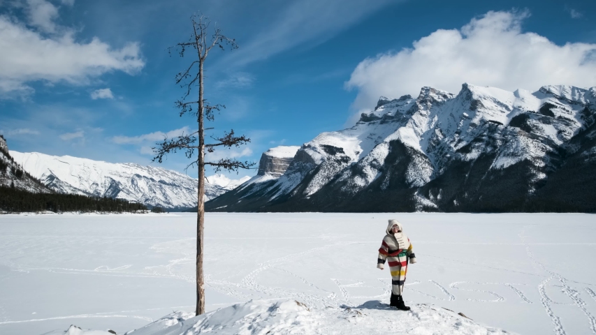Winter Tourist is Happy to View the Incredible Landscape, Banff Canada. An Indigenous Female Travels to Two Jack Lake in a National Park to Discover the Scenic Mountain Lookout, Handheld Wide in UHD