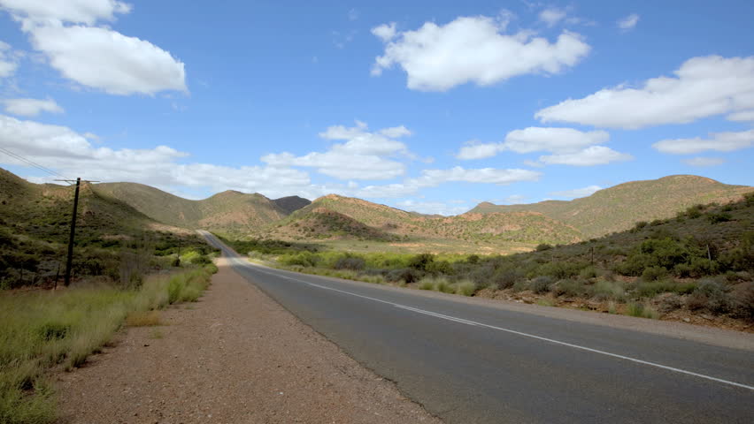 time-lapse, cars move through panoramic view of Route 62 in South Africa.