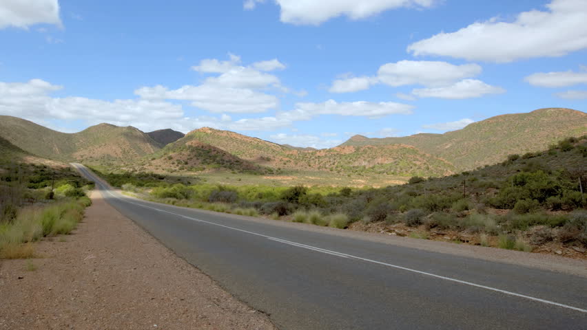 time-lapse, cars move through panoramic view of Route 62 in South Africa.
