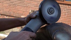 sawing off metal with a grinder. 4K video, 60 FPS