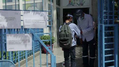 RABAT, MOROCCO: A school guard checks for a fever with a digital thermometer for a group of children to protect against the coronavirus covid-19. 25/08/2020 in Rabat