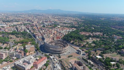 Aerial view of Colosseum in Rome, famous ancient amphitheater in ancient city center - landscape panorama of Italy from above, Europe