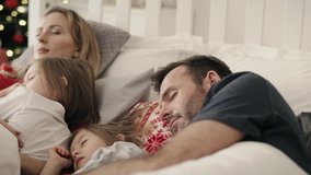 Video of family sleeping together in bed on Christmas morning.  Shot with RED helium camera in 8K.