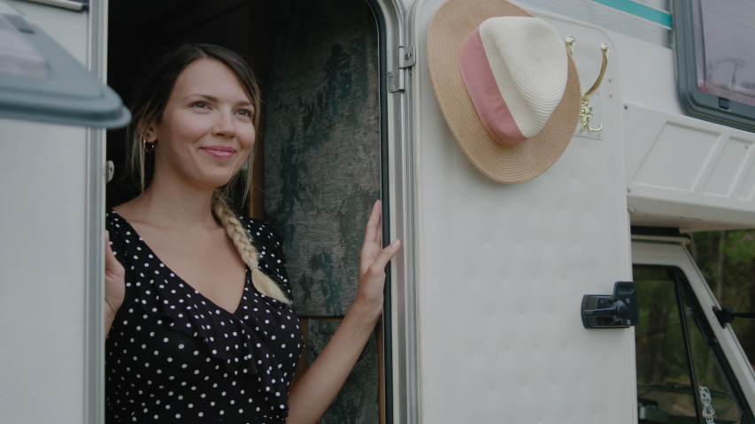 Smiling woman enjoyng vacation and standing in motor home RV campervan. Traveling in recreational vehicle.
 | Shutterstock HD Video #1058311792