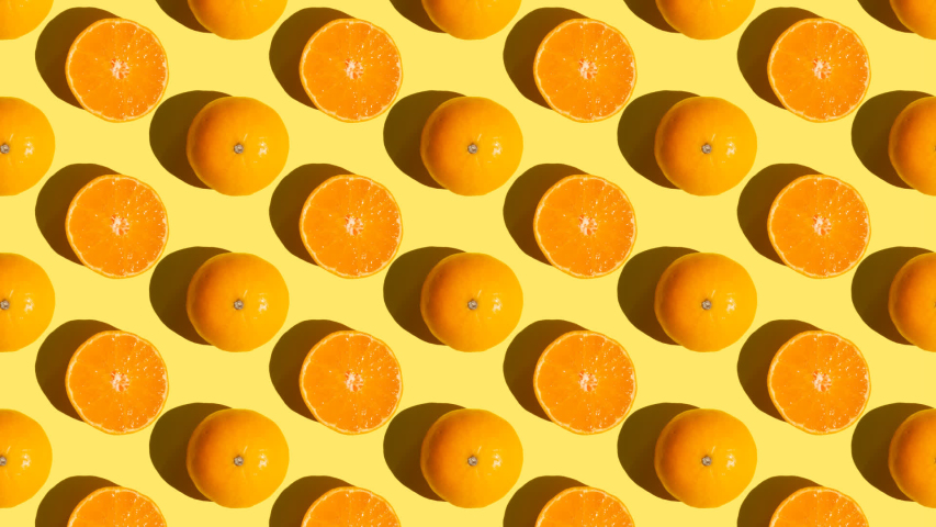 Stop motion Cut and whole tangerines alternate from left to right over orange background Royalty-Free Stock Footage #1058321014