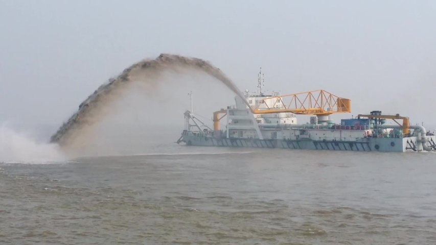 Dredging Vessel in action to keep waterways navigable, excavate and gathering sediments in the bottom and disposing at another location, Shanghai river, China Royalty-Free Stock Footage #1058325601